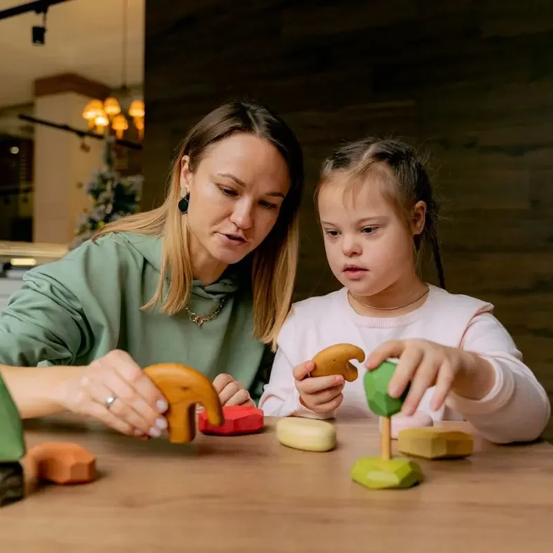 Therapist and child engaging in a speech therapy activity while considering "Is Speech Therapy Covered by Medicare"