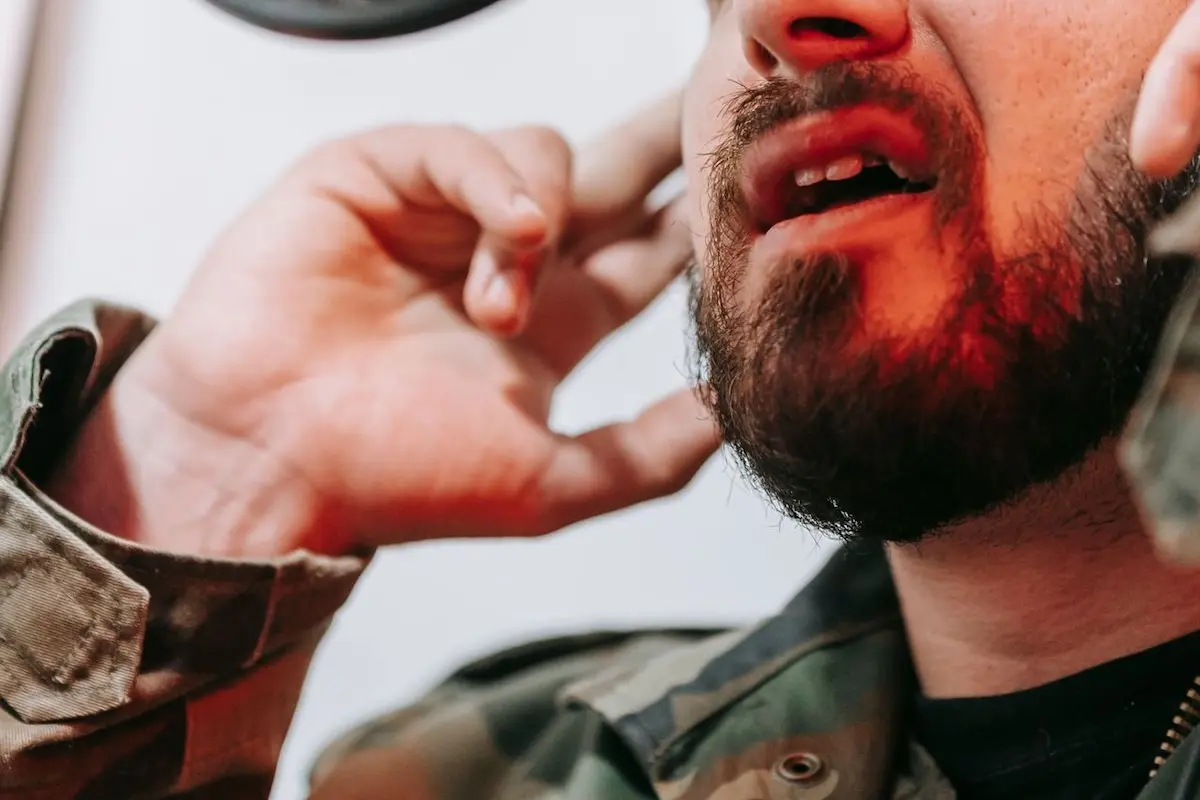 A man speaking through a microphone, an image representing the question of "can you develop speech impediment as an adult?"