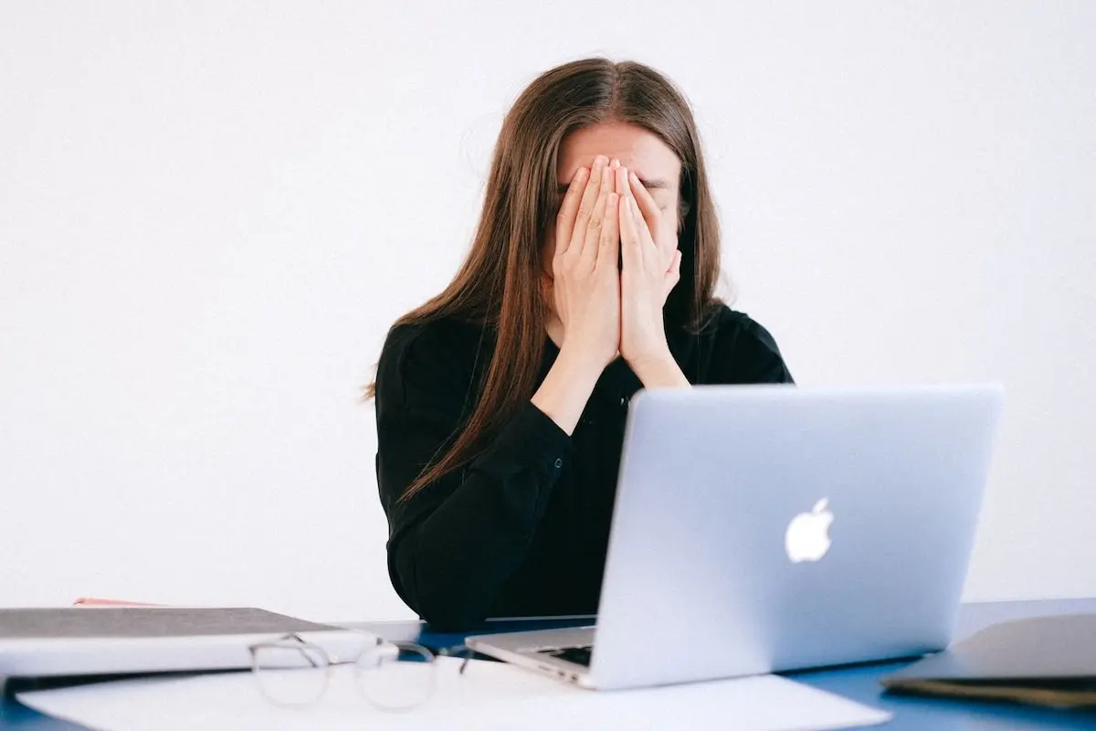 A woman in front of her laptop who's dealt with NDIS application rejections