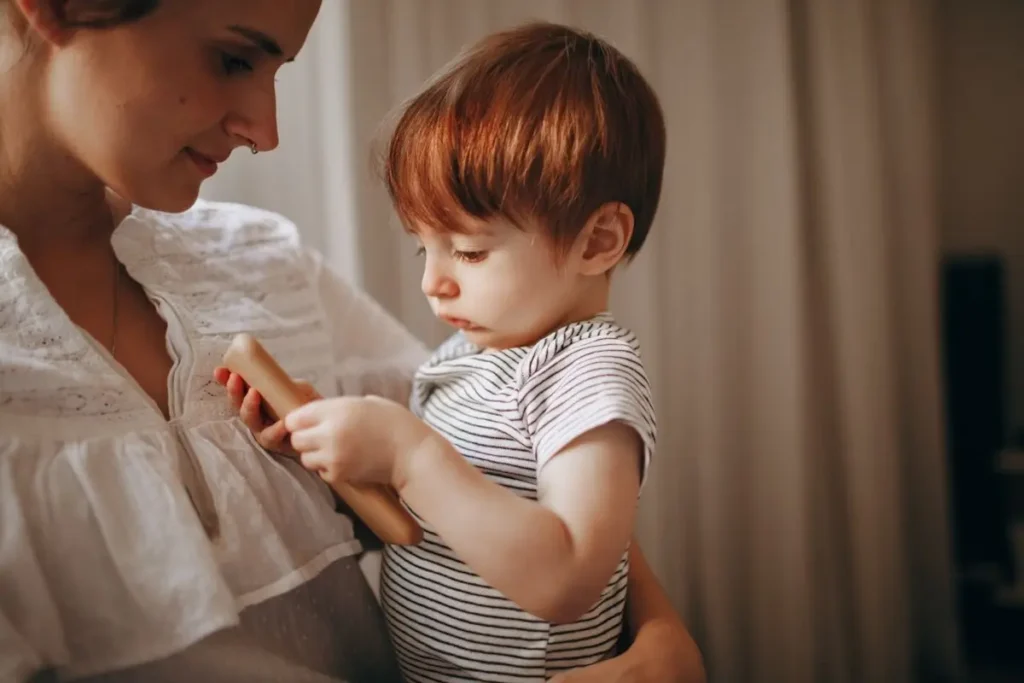 A mother looking at her child wondering when does a 2-year-old need speech therapy