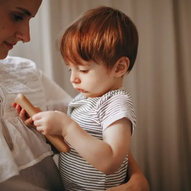 A mother looking at her child wondering when does a 2-year-old need speech therapy